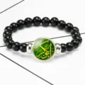 Black bead elastic bracelet featuring Arabic calligraphy Abu Bakr on green glass gem - Black