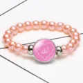 Elegant pink pearl stretch bracelet featuring a central Allah Arabic script glass charm - Pink