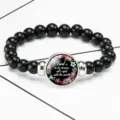 Detailed close-up of the time gem stretch bracelet featuring a floral quote charm - 12032508