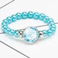 Macro shot of a blue beaded stretch bracelet featuring a biblical Psalm 91:4 quote - 12032509