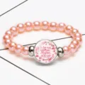 Close-up detail of pink pearl stretch bracelet featuring a biblical quote time gem pendant - 12032512