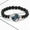 Close-up of black beaded stretch bracelet featuring a Bible verse glass cabochon center - 12032513