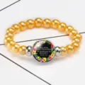 Close-up of golden beaded bracelet with Proverbs 4:23 bible verse glass cabochon - 12032515