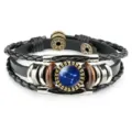 Detail of vintage leather bracelet featuring blue Gemini constellation glass gem cabochon. - Gemini