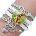 Close-up of multilayered braided bracelet with Golden Retriever puppy time gem charm - 12008705 (Golden Retriever Puppy-Mint Green)