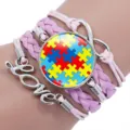 Detailed view of handmade pink woven autism awareness puzzle bracelet with Love charm - 12038608
