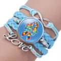 Handmade blue braided autism awareness bracelet with puzzle ribbon and Love charm - 12038611