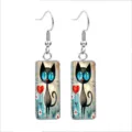 Detailed view of rectangular glass earrings with cute black cat and heart illustration - 10x25mm / Black Cat & Daisies