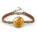 Detail of vintage suede rope bracelet with Van Gogh Sunflower art glass cabochon centerpiece. - Sunflowers (#02)