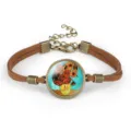 Detail view of Van Gogh's Sunflowers painting in a glass cabochon on a brown cord bracelet - Sunflowers II (#10)