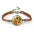 Detail view of Van Gogh sunflower painting glass cabochon bracelet with brown cord - Sunflowers III (#12)
