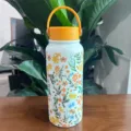 Gourde isotherme en acier inoxydable blanc avec motif floral et poignée orange - Couvercle Orange Floral (Fig 2) / 1000ml / Blanc