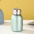 Mini light green stainless steel insulated vacuum flask featuring a portable metal carry ring - 300ml / Green