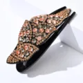 Close up detail of elegant rhinestone fishtail hair claw clip sparkling crystals leaf design - Transparent Gray + Champagne Zircon