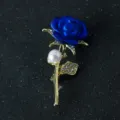 Blue rose flower brooch featuring a pearl and sparkling rhinestones, elegant fashion jewelry. - Blue