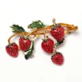 Gold-tone strawberry branch brooch with vibrant red enamel fruit and green leaf details. - Creative Strawberry Style (D-1293)