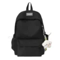 Black nylon school backpack detail featuring front zipper pocket and cute plush pendant charm. - Without Pendant / Black