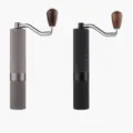 Manual coffee grinder detail view showing dual color options with stainless steel handle. - New Five-Star Style / Black