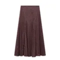 Detailed view of women's long A-line skirt featuring dark brown fabric and pink polka dots. - XS / Bottoms