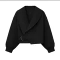 Black cropped jacket detail view, wide shawl lapel, side buckle belt, stylish ribbed cuffs. - Black