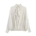 Elegant white polka dot blouse featuring a chic bow tie neck and long sleeves for women. - S / Tops / White