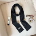 Detail view of a cozy dark grey winter knitted scarf, solid color, soft woolen blend fabric. - Dark Gray