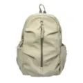 Dettaglio di uno zaino beige con motivi a stelle argentate e cerniera frontale verticale. - Kaki