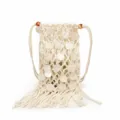 Detailed view of handmade white macramé phone bag with shell sequins and long tassel fringe - Off White