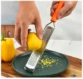 Stainless steel lemon zester and cheese grater with orange handle for kitchen food prep. - Style 1 / OPP Bag Packaging