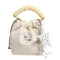 Cute beige fabric bucket bag with yellow scrunchie handle and polka dot star charm detail - White