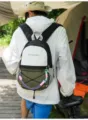 Back view of a person wearing a MARS SOCIETY outdoor travel backpack in a camping setting - With Lanyard / L / Black