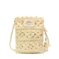 Close-up of handmade cream crochet crossbody phone bag with shell charm and STUDIO label - Starfish Style / Off White