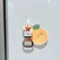 Close-up detail of the cute cartoon chef fridge magnet bottle opener with orange card. - Chef Style A / 4*10cm