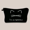 Close-up of black canvas makeup bag with cute white cat print and cat pun text - Black Minimalist Cat Quote (hzb885)