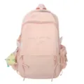 Vue détaillée du sac à dos rose pour filles avec broderie et petit pendentif mignon - Rose