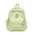 Detail eines hellgrünen Schulrucksacks im Preppy-Stil mit weißen Sternen und Logo - Grün