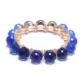 Dark blue faceted crystal bead bracelet with gold tone settings and elastic cord design. - Dark Blue