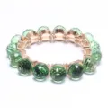 Green faceted crystal ball stretch bracelet with gold settings, elegant fashion jewelry. - Light Green