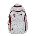 Gros plan d'un sac à dos d'écolier blanc avec motifs d'étoiles rouges et zips étoiles - Étoile Rouge