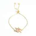 Gold-tone adjustable slider bracelet featuring a pink heart zircon and dagger pendant. - Gold Sword Pink Heart