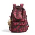 Front pocket detail of camo school backpack showing MGDCH lettering and plush bear charm - Red