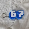 Detail view of the blue and white number 67 fidget clicker keychain with metal ring. - Dark Blue