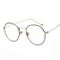 Elegante montura de gafas redondas de metal vintage anti-luz azul en negro y oro - Montura Dorada Aro Negro