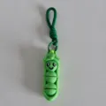 Detail view of 3D printed green vegetable cartoon keychain pendant with woven lanyard. - Pea Pod