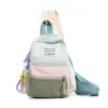 Detail shot of a pastel nylon chest bag with MARS SOCIETY patch and star keychain accessory. - With Charm / S / Light Blue