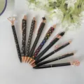 9-piece black ballpoint pen set with rose gold accents, diamond and crown decorative top. - Black