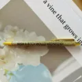Gold glitter click ballpoint pen with funny quote, stylish metallic desk writing stationery. - Wednesday