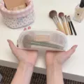 Detailed view of the portable white mesh makeup brush pouch with zipper closure - S / White