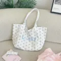 Detailed view of white canvas tote bag with star print and 'Lucky' embroidery. - Star Pattern / White