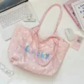 Close-up detail of the pink polka dot canvas tote bag with blue Lucky embroidery - Polka Dot Blue Letter Style / Pink